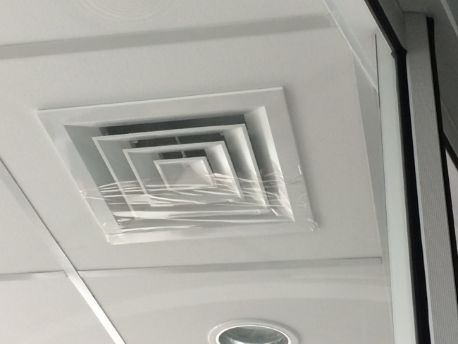 An airconditioning vent is mostly covered with tap in order to obstruct air flow